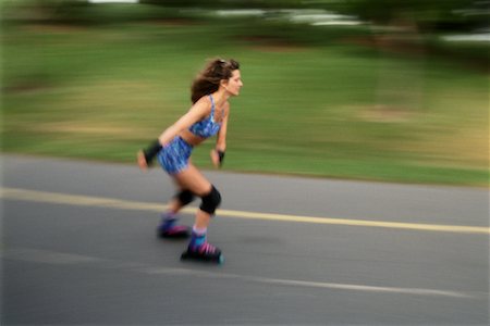 simsearch:700-00029428,k - Woman In-Line Skating on Road Foto de stock - Con derechos protegidos, Código: 700-00016116