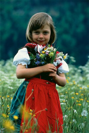 Portrait of Girl Holding Flowers Outdoors Stock Photo - Rights-Managed, Code: 700-00016198