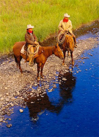 Cowboys on Horses by Stream Douglas Lake Ranch British Columbia, Canada Foto de stock - Con derechos protegidos, Código: 700-00016611