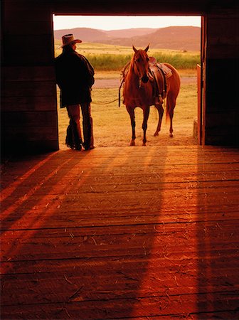 Man and Horse by Barn Entrance Douglas Lake Ranch British Columbia, Canada Stock Photo - Rights-Managed, Code: 700-00016612
