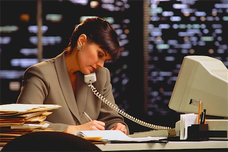 simsearch:700-00032848,k - Businesswoman Using Telephone Near Window at Night Stock Photo - Rights-Managed, Code: 700-00017793