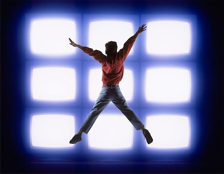 Back View of Boy Jumping in Front Of Monitors Stock Photo - Rights-Managed, Code: 700-00018006