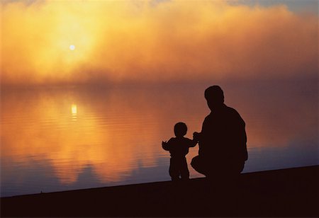 family holding hands on beach at sundown - Silhouette of Father and Child at Six Mile Lake Muskoka, Ontario, Canada Stock Photo - Rights-Managed, Code: 700-00018621