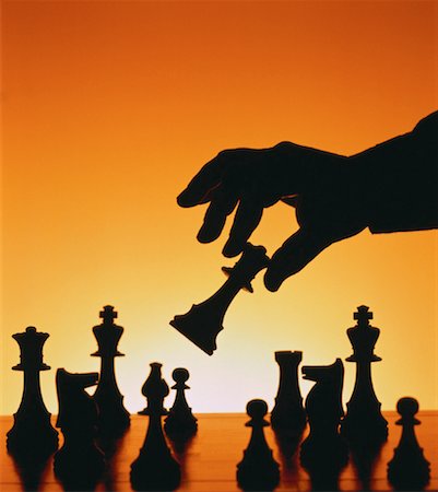 simsearch:700-00051669,k - Silhouette of Hand Moving Chess Piece Stock Photo - Rights-Managed, Code: 700-00019193