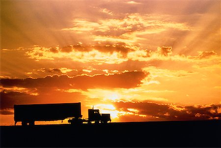 side view of a semi truck - Silhouette of Transport Truck on Road at Sunset Stock Photo - Rights-Managed, Code: 700-00011095