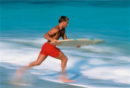 skimboard - Man Skimboarding in Swimwear Miami, Florida, USA Foto de stock - Direito Controlado, Número: 700-00024491