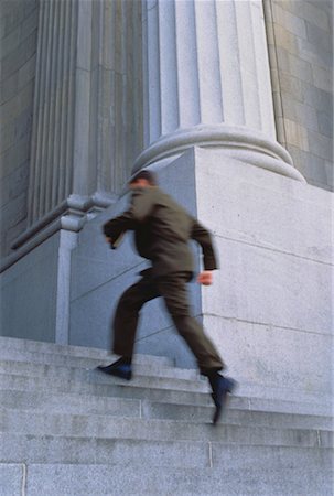 run suit low angle - Businessman Running Up Stairs Outdoors Stock Photo - Rights-Managed, Code: 700-00024905