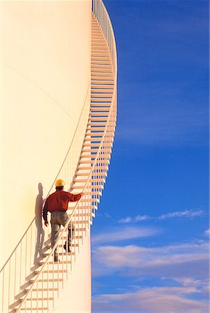 spiral staircase people - Workman Walking Up Side of Storage Drum Stock Photo - Rights-Managed, Code: 700-00025900