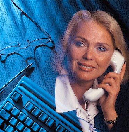 Businesswoman, Financial Pages And Computer Keyboard Stock Photo - Rights-Managed, Code: 700-00026070