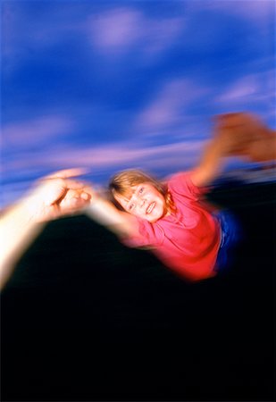 Person's Perspective of Swinging Child By Arms Outdoors Stock Photo - Rights-Managed, Code: 700-00026441