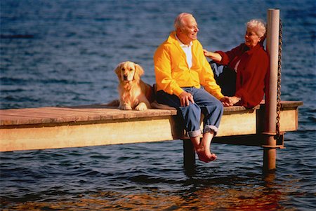 senior couple with pet - Mature Couple and Golden Retriever Sitting on Dock Stock Photo - Rights-Managed, Code: 700-00026662