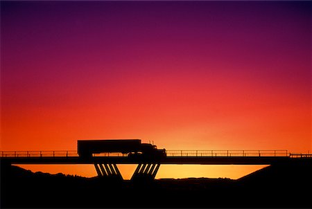 Silhouette of Transport Truck on Bridge at Sunset Stock Photo - Rights-Managed, Code: 700-00026682
