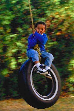 Portrait of Boy on Tire Swing Stock Photo - Rights-Managed, Code: 700-00026864