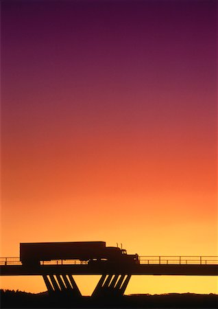 Silhouette of Transport Truck on Bridge at Sunset Stock Photo - Rights-Managed, Code: 700-00026955