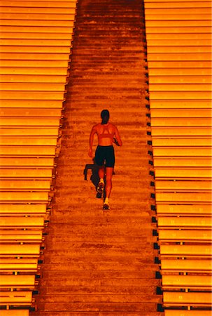 simsearch:700-00060793,k - Back View of Woman Running Up Stadium Steps Stock Photo - Rights-Managed, Code: 700-00029189