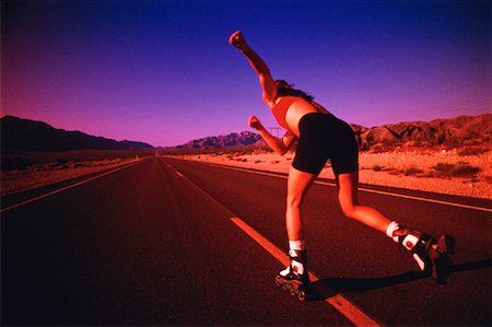 simsearch:700-00029428,k - Back View of Woman In-Line Skating on Road at Dusk Foto de stock - Con derechos protegidos, Código: 700-00029246