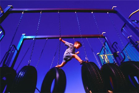 Boy Climbing over Tire Swings Stock Photo - Rights-Managed, Code: 700-00029264