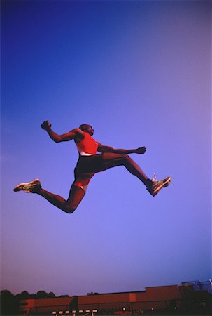 salto in lungo - Man Long Jumping Fotografie stock - Rights-Managed, Codice: 700-00029795