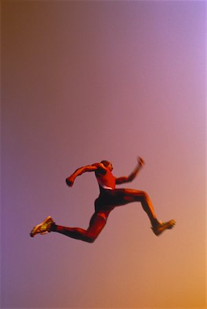 salto in lungo - Man Long Jumping Fotografie stock - Rights-Managed, Codice: 700-00029796