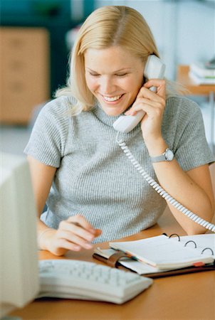 Businesswoman Using Telephone and Computer Foto de stock - Con derechos protegidos, Código: 700-00029946