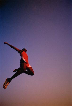 salto em distância - Man Long Jumping Foto de stock - Direito Controlado, Número: 700-00029955