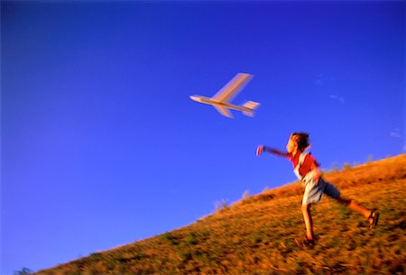 Child Throwing Toy Glider Outdoors Stock Photo - Rights-Managed, Code: 700-00020314