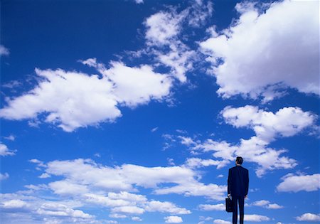 Back View of Businessman and Clouds Fotografie stock - Rights-Managed, Codice: 700-00020706