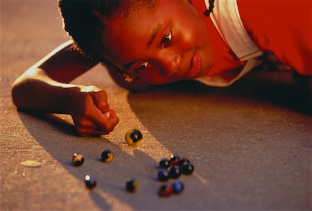 Close-Up of Girl Playing Marbles Stock Photo - Rights-Managed, Code: 700-00021241