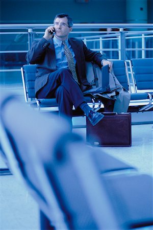 Businessman Using Cell Phone and Laptop Computer at Airport Stock Photo - Rights-Managed, Code: 700-00034709