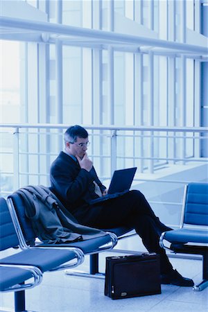 Businessman Using Laptop Computer at Airport Stock Photo - Rights-Managed, Code: 700-00034710