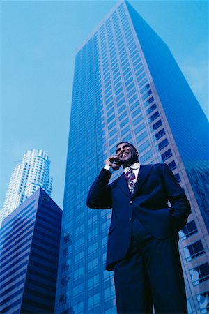 skyscraper company suit - Businessman Using Cell Phone Outdoors Stock Photo - Rights-Managed, Code: 700-00034997