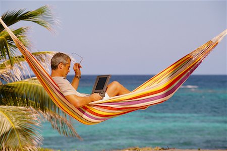 Businessman Lying in Hammock Using Laptop Computer Outdoors Stock Photo - Rights-Managed, Code: 700-00035154