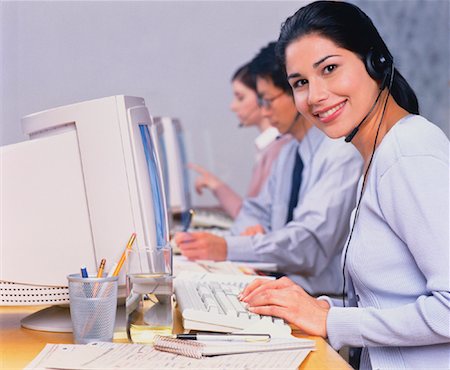 Portrait of Businesswoman with Telephone Headset at Computer Stock Photo - Rights-Managed, Code: 700-00035334