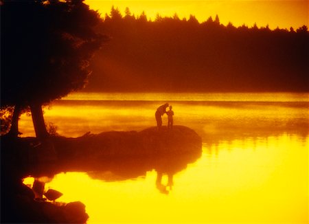 picture granddaughter fishing with grandpa - Grandfather and Child Fishing At Sunset Stock Photo - Rights-Managed, Code: 700-00036571