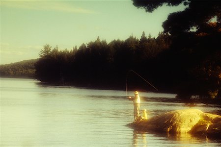 picture granddaughter fishing with grandpa - Grandfather and Child Fishing From Rock Stock Photo - Rights-Managed, Code: 700-00036572