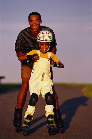 ethnic children roller skating images - Portrait of Father and Daughter In-Line Skating Stock Photo - Rights-Managed, Code: 700-00036873