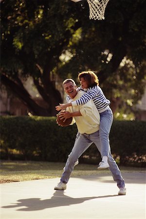 simsearch:700-00036910,k - Mature Couple Playing Basketball Outdoors Foto de stock - Con derechos protegidos, Código: 700-00036909