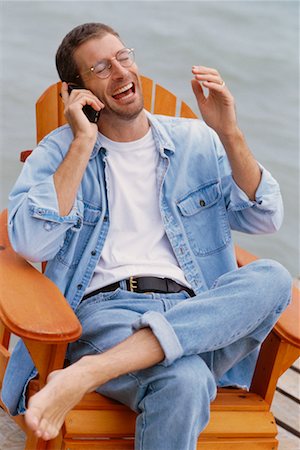 Man Using Cell Phone on Dock Stock Photo - Rights-Managed, Code: 700-00037297