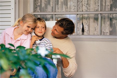 Father and Children Using Cordless Phone Stock Photo - Rights-Managed, Code: 700-00037306