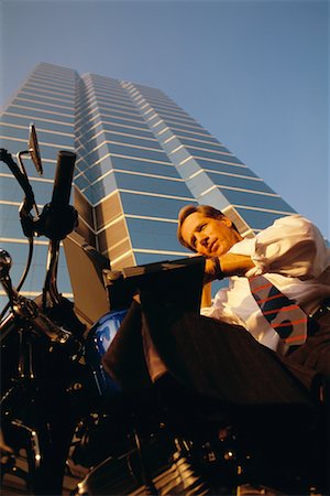 Businessman on Motorcycle Using Laptop Computer Stock Photo - Rights-Managed, Code: 700-00037625