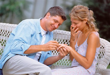 Man Putting Ring on Woman's Finger Outdoors Foto de stock - Con derechos protegidos, Código: 700-00037718