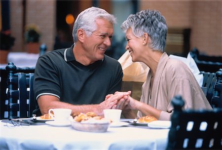 Mature Couple Holding Hands at Outdoor Cafe Stock Photo - Rights-Managed, Code: 700-00037792