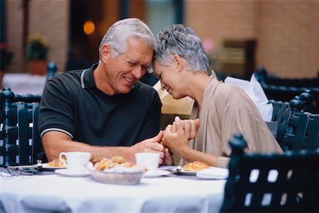 Mature Couple Holding Hands at Outdoor Cafe Stock Photo - Rights-Managed, Code: 700-00037793