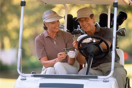 Mature Couple in Golf Cart Foto de stock - Direito Controlado, Número: 700-00037996