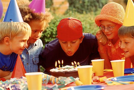 simsearch:700-00064984,k - Boy Blowing Out Candles on Cake Outdoors Fotografie stock - Rights-Managed, Codice: 700-00038299