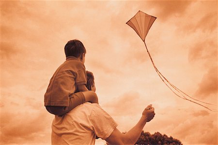 Back View of Father and Son Flying Kite Stock Photo - Rights-Managed, Code: 700-00038633