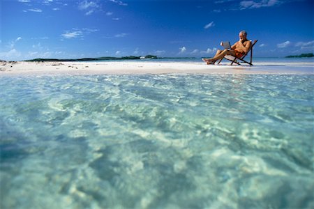 Mature Man Sitting on Beach with Laptop Computer Stock Photo - Rights-Managed, Code: 700-00038656