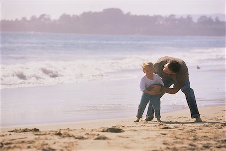 father and son playing football at beach - Father and Son on Beach with Football Stock Photo - Rights-Managed, Code: 700-00038793
