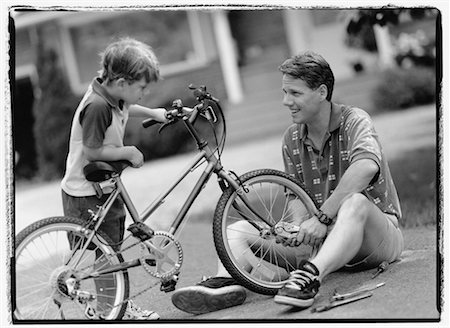 simsearch:700-00038126,k - Father and Son Fixing Bicycle Outdoors Foto de stock - Con derechos protegidos, Código: 700-00039047