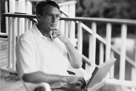 Man Using Laptop Computer on Porch Stock Photo - Rights-Managed, Code: 700-00039171